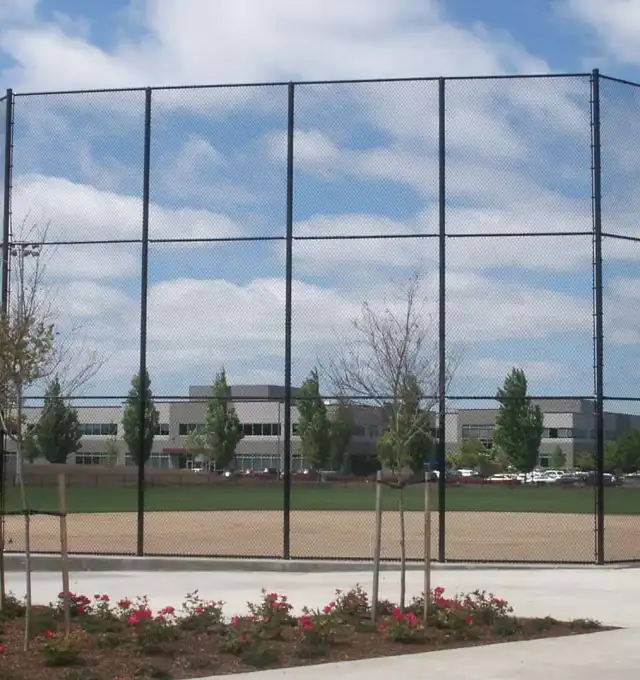 Black chain link fence around a ball field in Portland, installed by Pacific Fence & Wire
