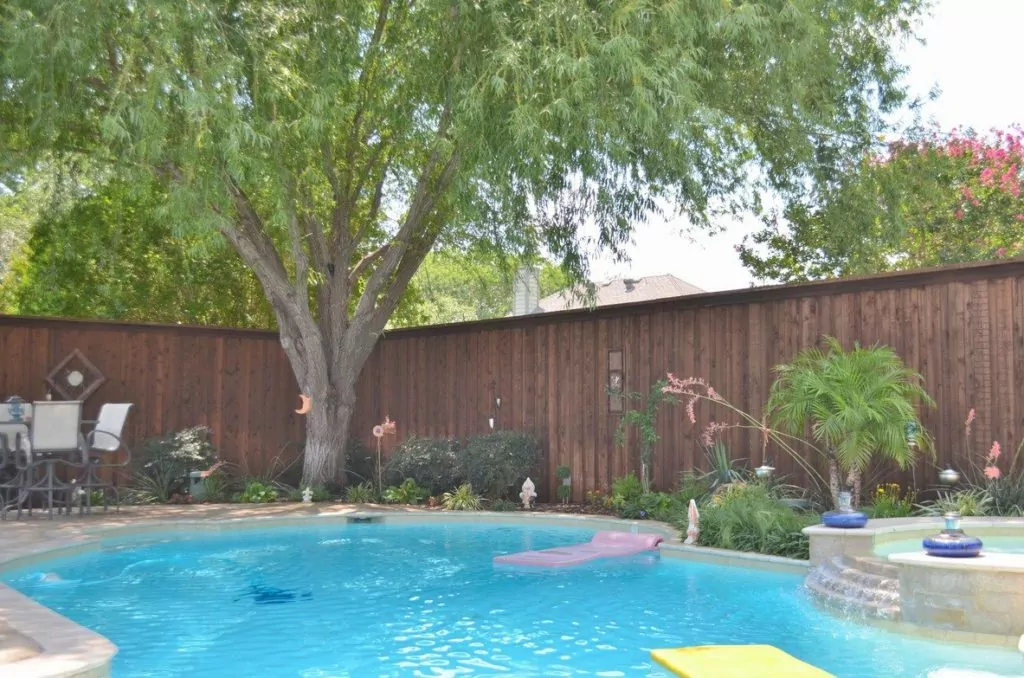 Beautiful brown fence around a well-kept pool