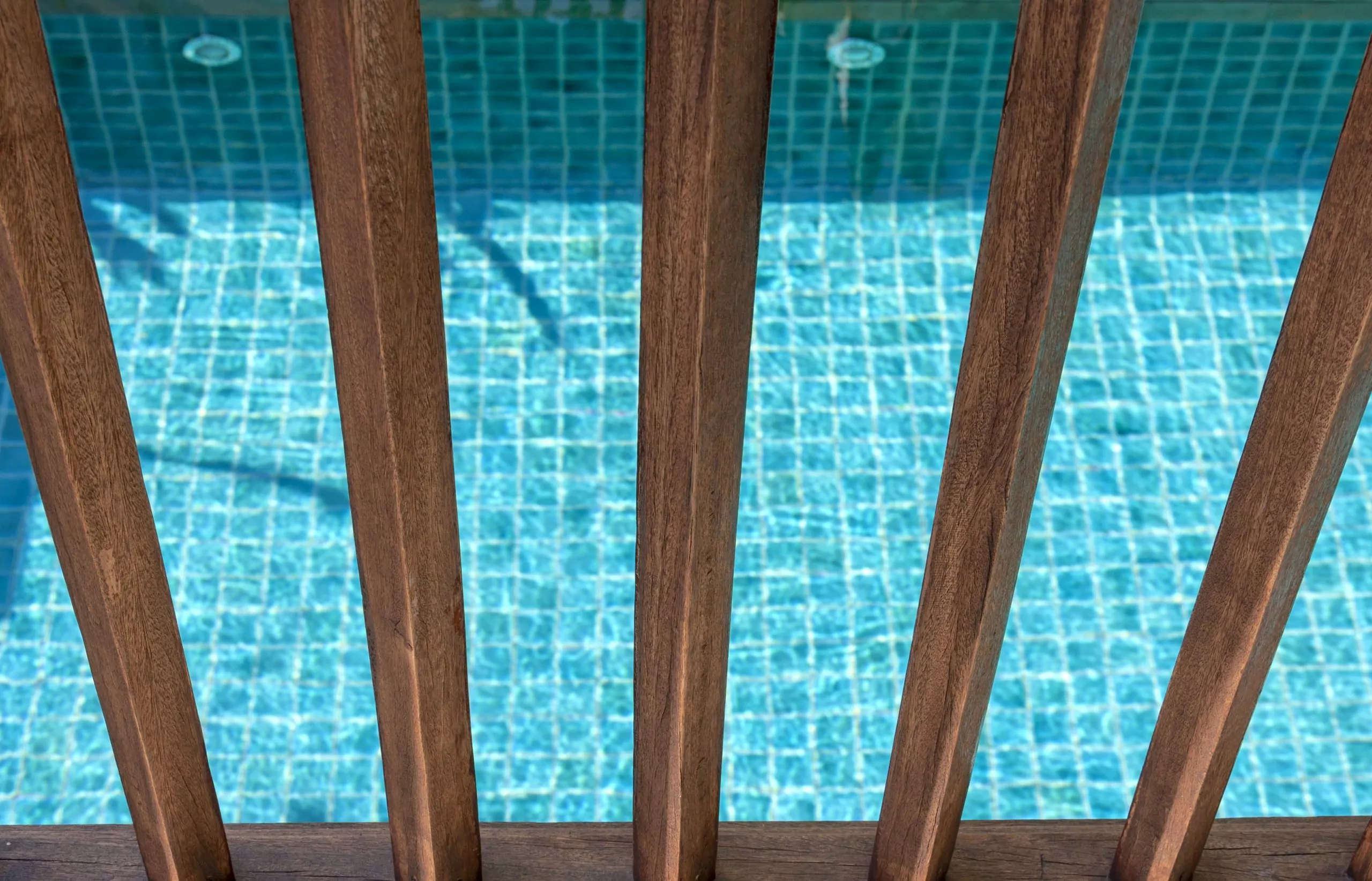 Wooden fence with swimming pool background