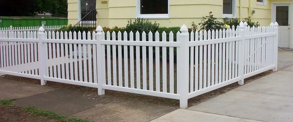 vinyl picket fence in front of a home.