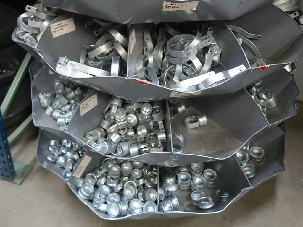 A bin of various fence fittings