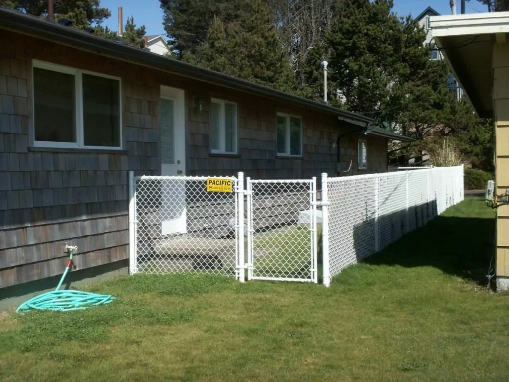 Bright, new chain link fence around the entrance of a home