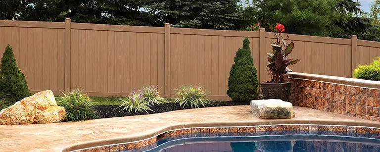 Vinyl fencing alongside a pool to illustrate benefits of vinyl fencing