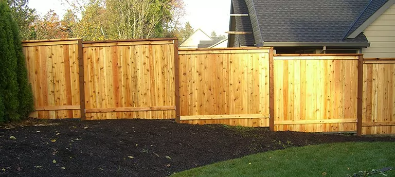 A residential wooden fence installation